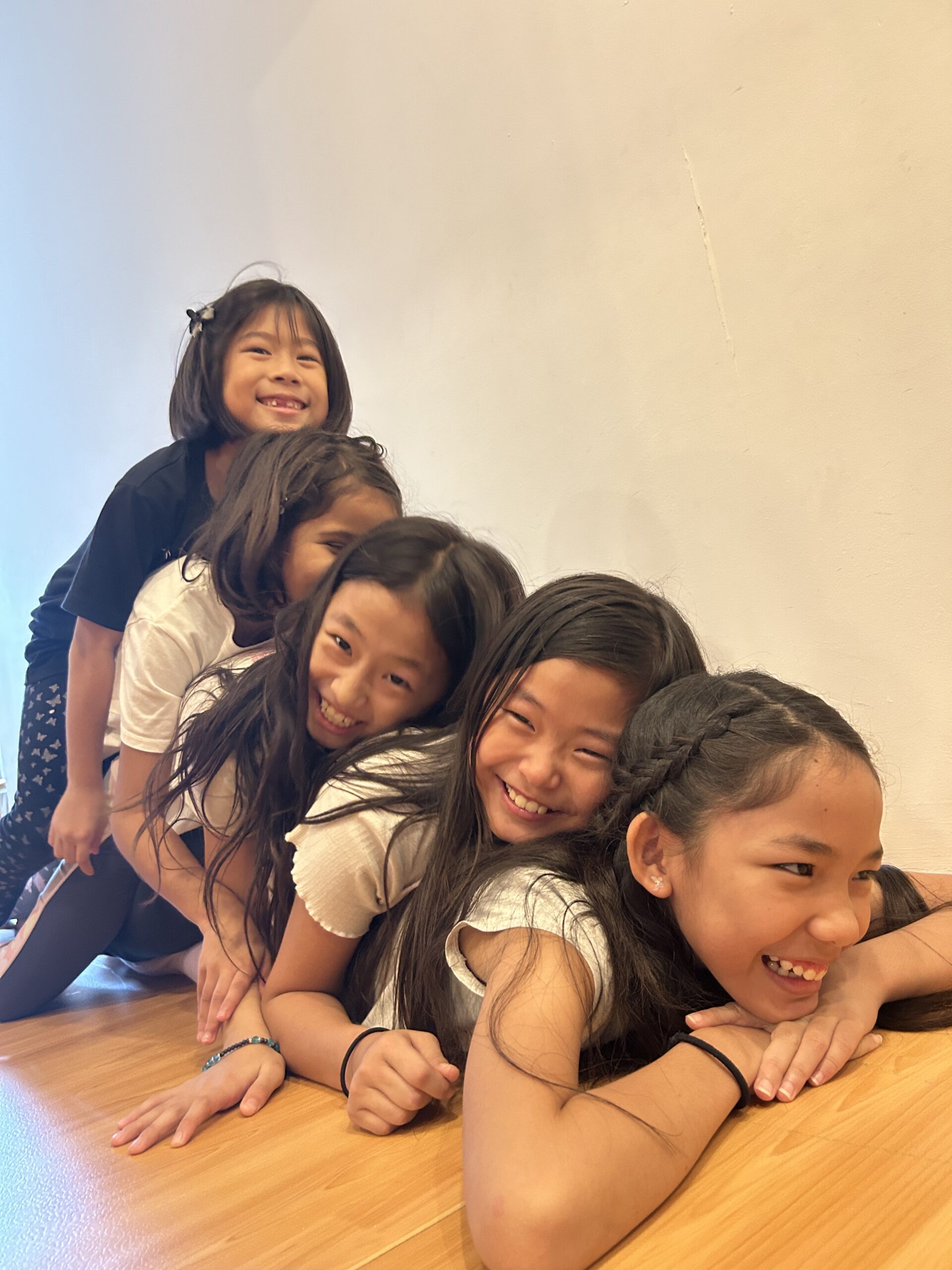Five girls laughing together at Mindful Space Singapore camp