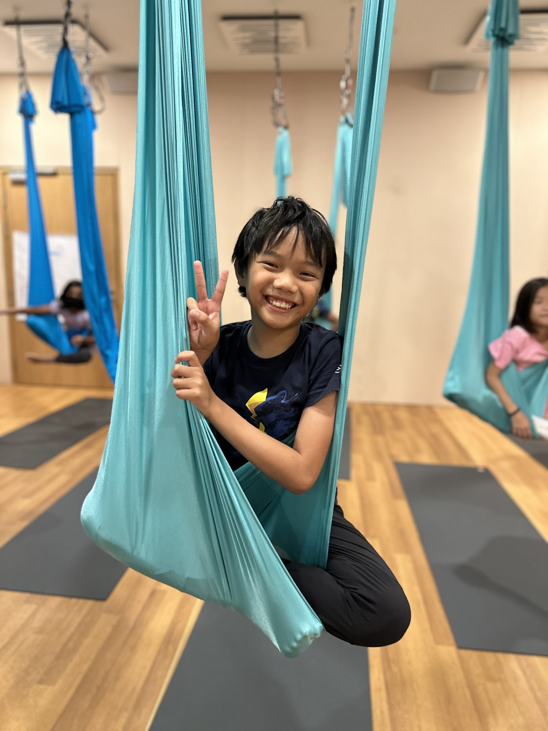 Child focused during aerial yoga
