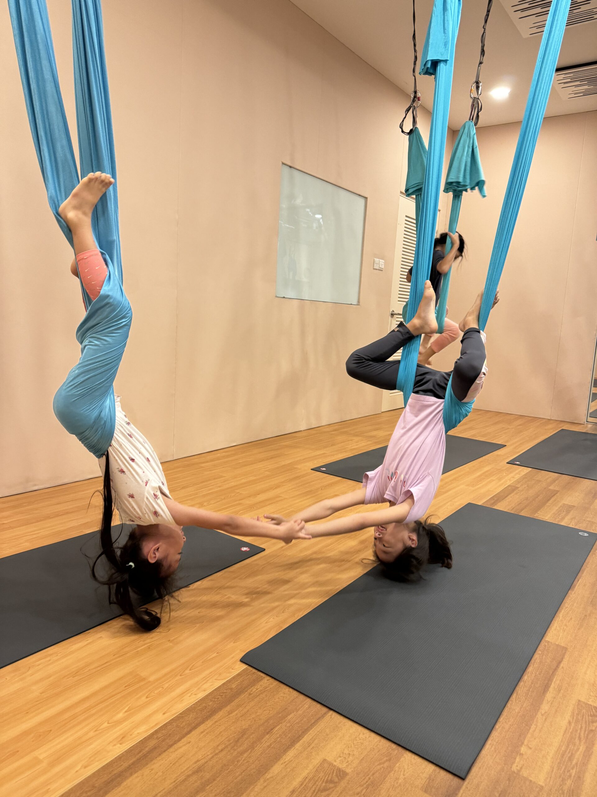 Child practising mindfulness in aerial hammock