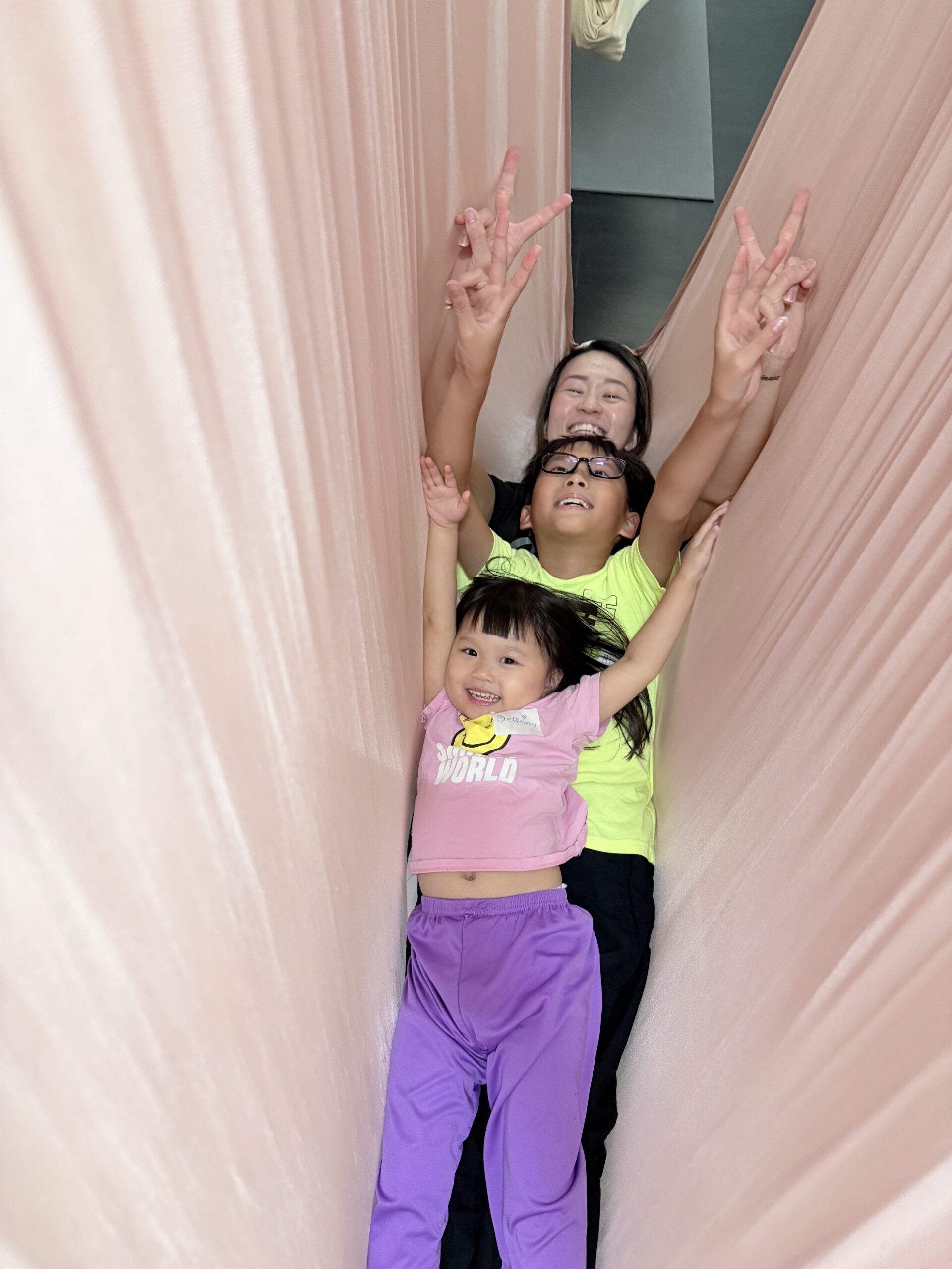 Family aerial yoga inversion pose, Mindful Space Singapore