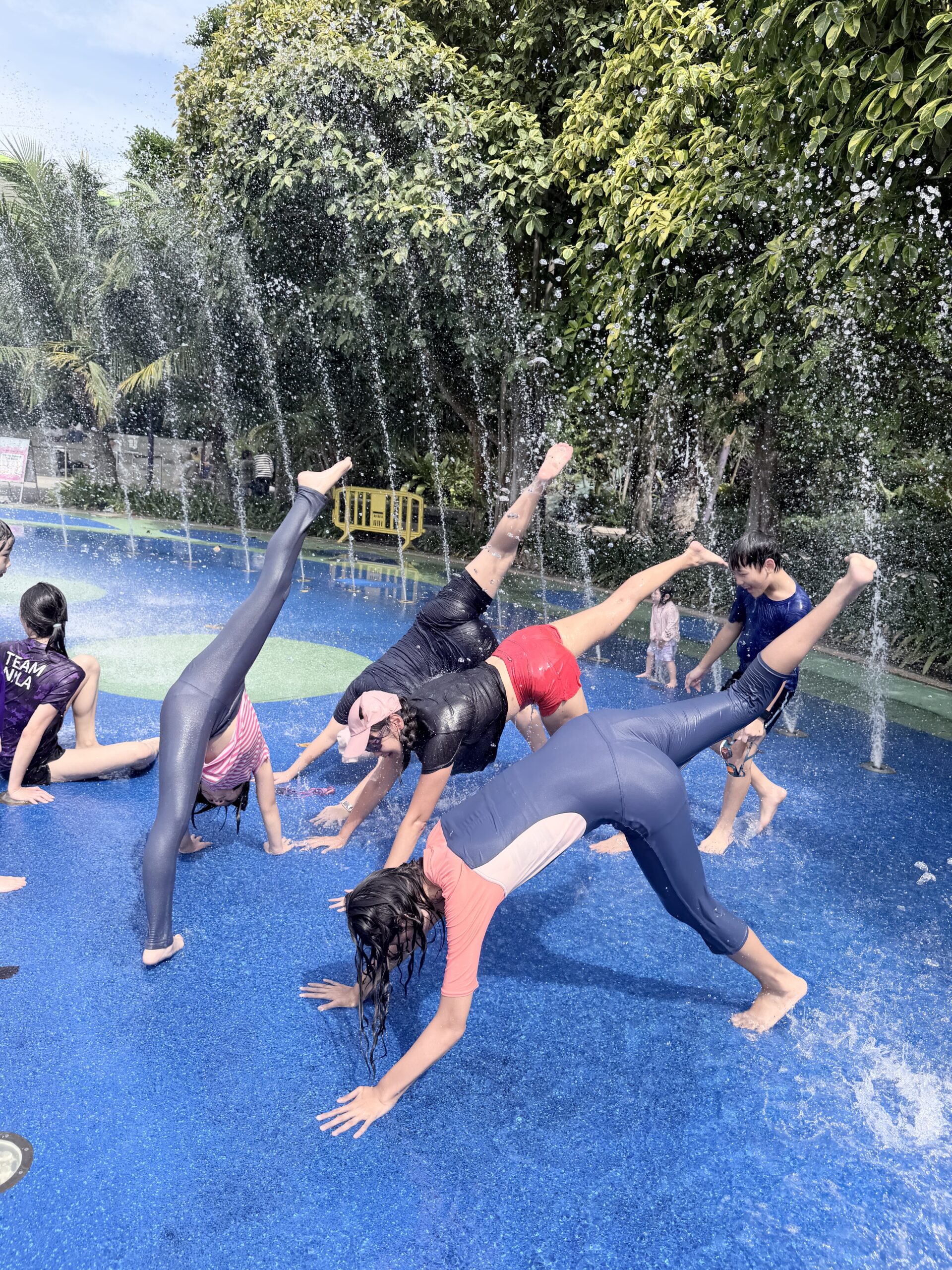 Children enjoying social water play at Singapore holiday camp
